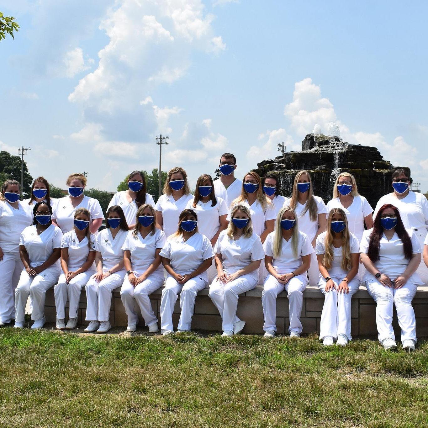 Nursing students posing for a photo in front of Updike Fountain